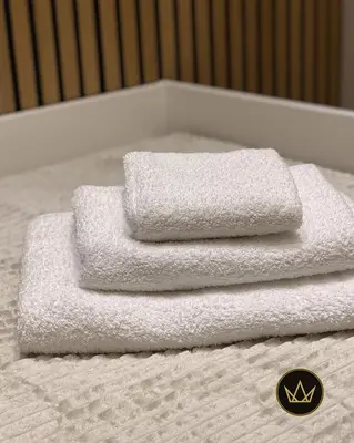 three towels sitting on top of a bed at Metropolitan Royal in Jagodina