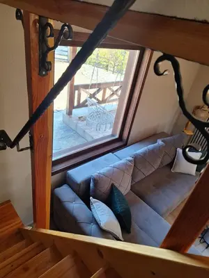 a couch in a room with a window at Planinska kuća Radulović in Goč