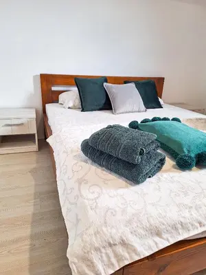 a bed with two pillows on top of it at Planinska kuća Radulović in Goč