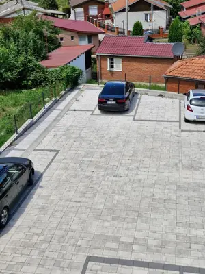 a parking lot with two cars parked in it at Apartman Curcic 1 in Soko Banja
