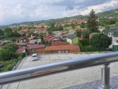 a car parked in a parking lot in a town at Apartman Ćurčić in Soko Banja