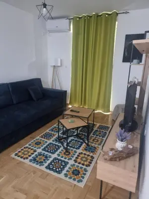 a living room with a couch and a table at Apartman NIKA Vrnjačka Banja in Vrnjačka Banja