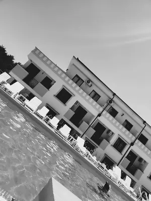 a large building next to a body of water at Apartman NIKA Vrnjačka Banja in Vrnjačka Banja