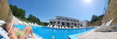 a woman laying on a pool at a resort at Apartman NIKA Vrnjačka Banja in Vrnjačka Banja