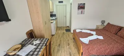 a small room with a bed with towels on it at Suncani Breg in Soko Banja