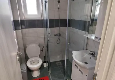 a bathroom with a shower and a toilet and a sink at Suncani Breg in Soko Banja