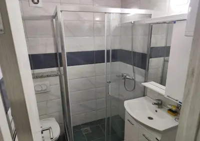 a bathroom with a shower and a toilet and a sink at Suncani Breg in Soko Banja