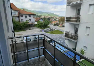 a balcony of a building with a view of a street at Suncani Breg in Soko Banja