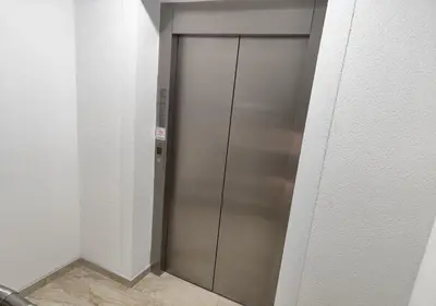 a elevator with a metal door in a room at Suncani Breg in Soko Banja