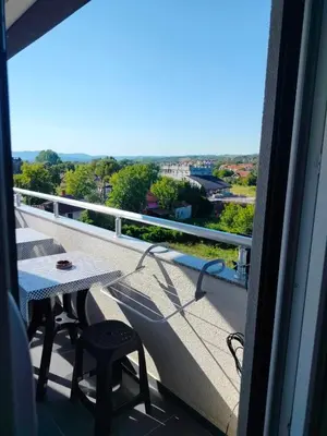 a balcony with a table and a view of the city at Studio Dimitrije 15 in Soko Banja