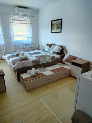 a bedroom with a large bed and a couch at Studio Marija 21 in Soko Banja
