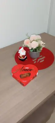 a red heart on a table with flowers on it at Studio Marija 21 in Soko Banja