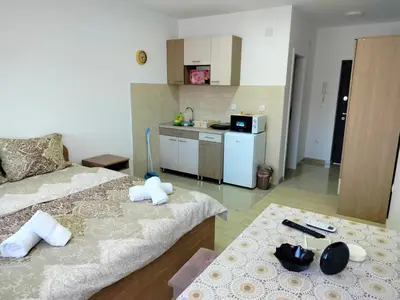 a small room with two beds and a kitchen at Studio Marija 21 in Soko Banja