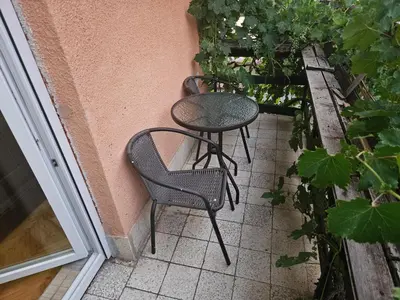 two chairs and a table on a patio at Apartmani,,Drljaca,,1 in Soko Banja