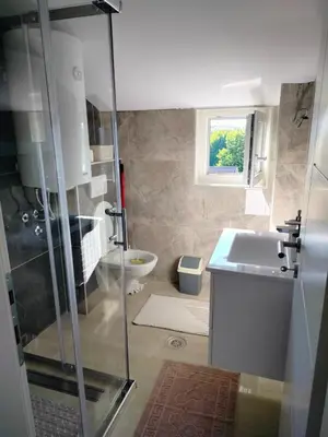 a bathroom with a shower and a sink and a toilet at Studio Marija 20 in Soko Banja