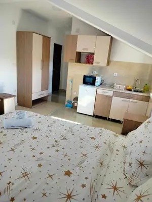 a room with a bed and a kitchen in it at Studio Marija 20 in Soko Banja