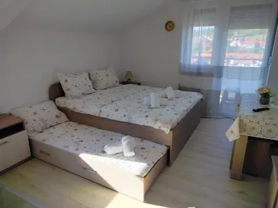 a small bedroom with a bed and a couch at Studio Marija 20 in Soko Banja