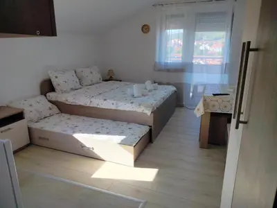 a small bedroom with two beds and a window at Studio Marija 20 in Soko Banja