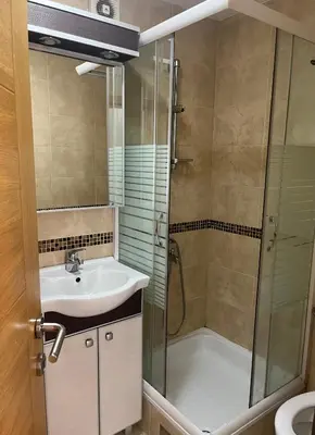a bathroom with a shower and a sink and a shower at Apartman Anja in Vrnjačka Banja