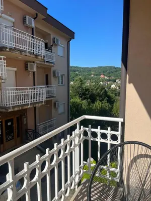 a balcony of a building with a bench on it at Apartman Anja in Vrnjačka Banja