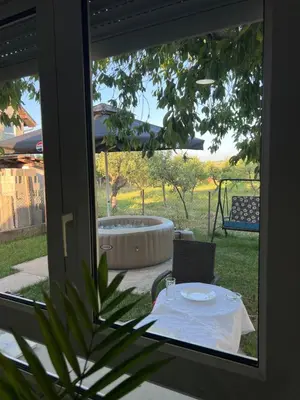 a table with a plate on it in front of a tub at Apartman Soni Jagodina- free jacuzzi, private parking, pet friendly in Kolonije