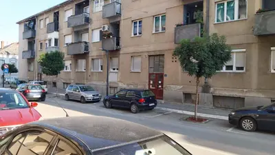 a group of cars parked on a city street at Apartman EmEm in Kuršumlija