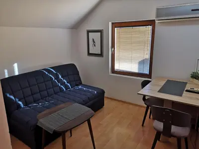 a living room with a couch and a table at Aparmani,,Drljaca,,3 in Soko Banja