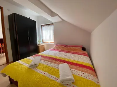 a bedroom with a bed with two towels on it at Aparmani,,Drljaca,,3 in Soko Banja