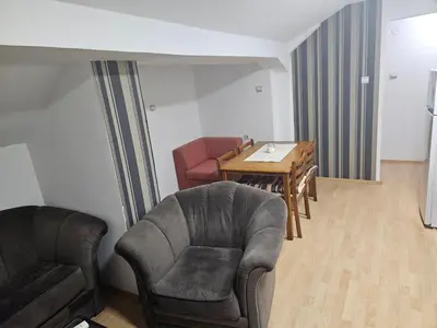 a living room with a chair and a table at Apartmani,,Drljaca,,4 in Soko Banja