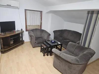 a living room with two chairs and a television at Apartmani,,Drljaca,,4 in Soko Banja