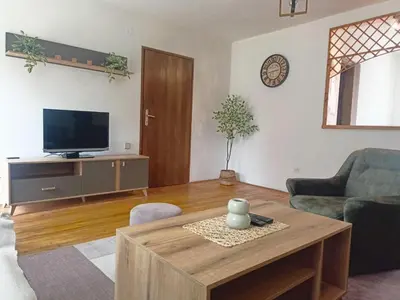 a living room with a tv and a coffee table at Vlasinsko jezero vila BiLiV in Surdulica