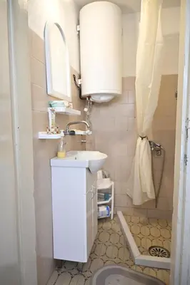 a small bathroom with a sink and a mirror at Mokino bunarče in Knjazevac.