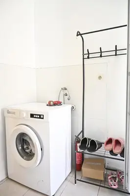 a laundry room with a washing machine and a shelf at Mokino bunarče in Knjazevac.
