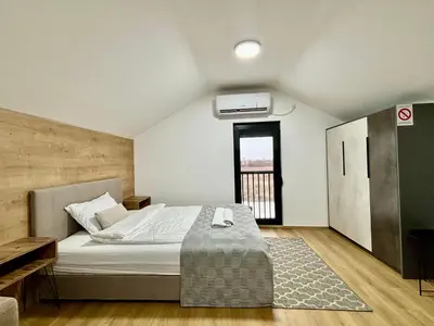 a bedroom with a bed and a large window at Promo Studio Apartment in Pirot