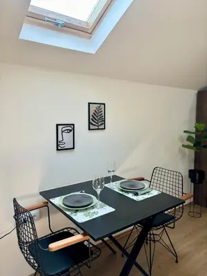 a dining room with a black table and chairs at Promo Studio Apartment in Pirot