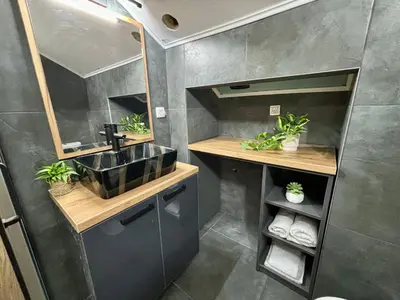 a small bathroom with a sink and a mirror at Promo Studio Apartment in Pirot