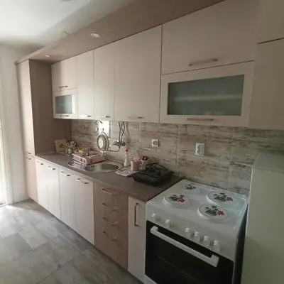 a kitchen with a white stove and a sink at Apartman Icić in Pirot