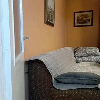 a bed in a room with a pillow on it at Apartman Icić in Pirot