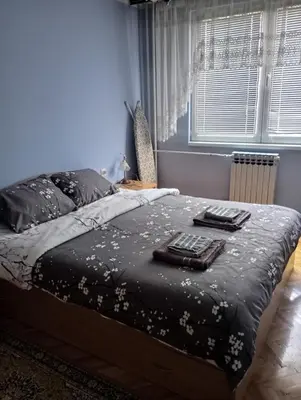 a bedroom with a bed with two towels on it at Apartman Icić in Pirot