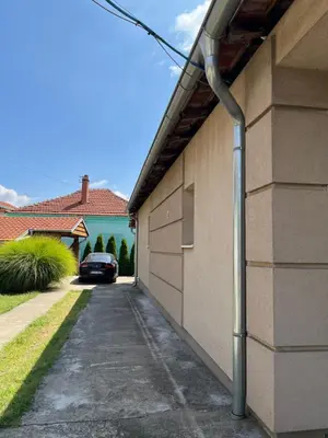 a driveway of a house with a car parked at Delux apartman in Leskovac