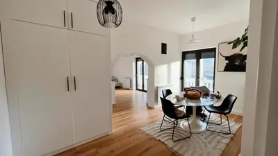 a kitchen and dining room with a table and chairs at Villa Sienna in Vrnjačka Banja