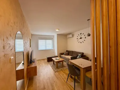 a living room with a couch and a table at Luxe Apartman Sokobanja in Soko Banja