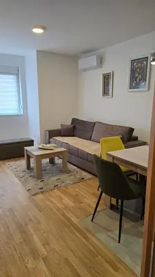 a living room with a couch and a table at Luxe Apartman Sokobanja in Soko Banja