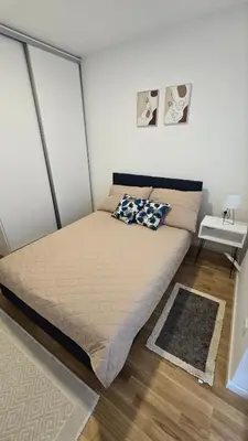 a bed with two pillows on it in a bedroom at Luxe Apartman Sokobanja in Soko Banja