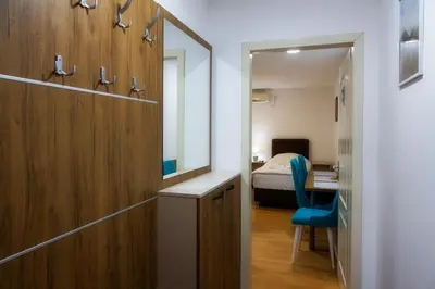 a room with a bedroom with a bed and a mirror at Sobe Lucky in Ribarska Banja