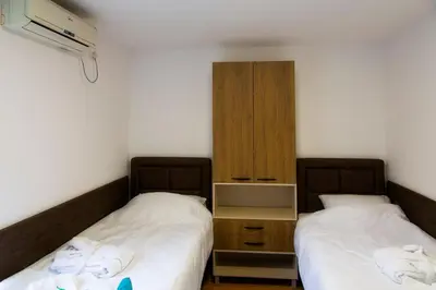 two beds sitting next to each other in a room at Sobe Lucky in Ribarska Banja
