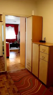 a room with a door open to a room with a kitchen at Spasojević Apartman in Kuršumlija