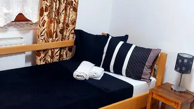 a bedroom with a bed with two towels on it at Spasojević Apartman in Kuršumlija