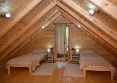 two beds in the attic of a log cabin at Deda Misina Koliba in Ćuštica