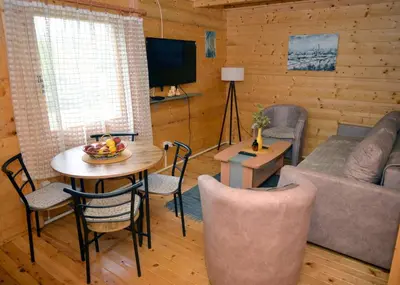 a living room with a couch and a table at Deda Misina Koliba in Ćuštica